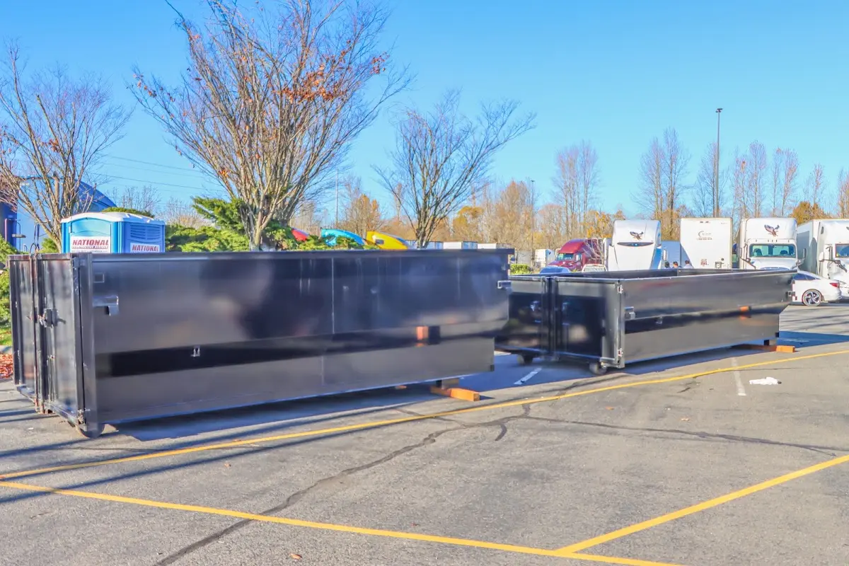 Professional dumpster rental service with roll-off container on residential driveway in Carlstadt